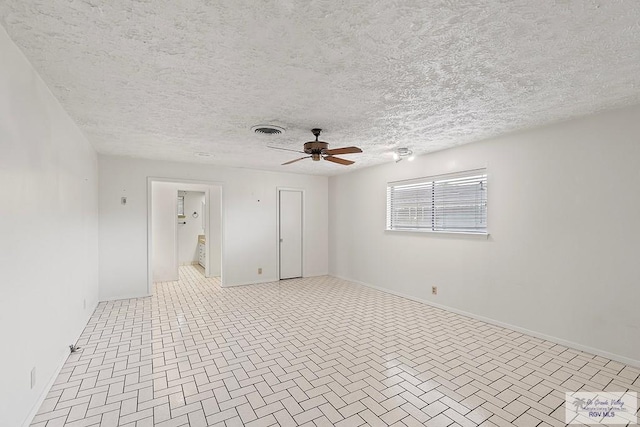 empty room featuring ceiling fan and a textured ceiling