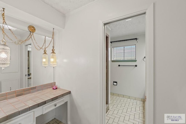 bathroom with a textured ceiling and tile patterned floors