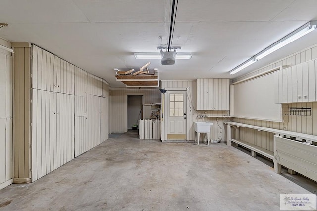 garage with sink and a garage door opener