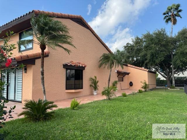 view of side of property with a lawn