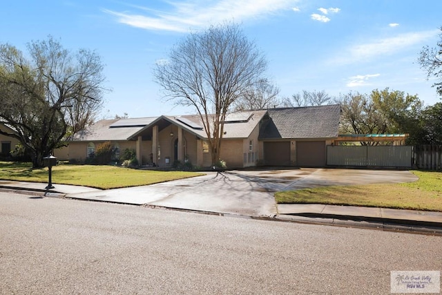 single story home featuring a garage and a front yard