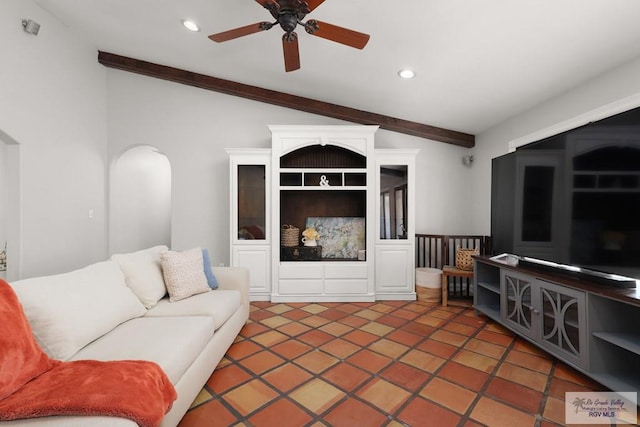 living room with ceiling fan, lofted ceiling with beams, and dark tile patterned flooring