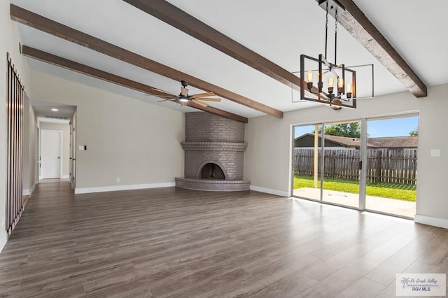 45 Varadero St, Brownsville, TX 78526 - unfurnished living room with a chandelier, baseboards, a brick fireplace, wood finished floors, and a ceiling fan