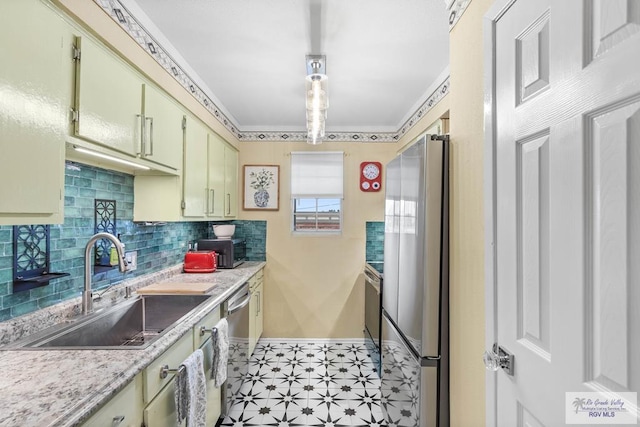 kitchen featuring stainless steel appliances, tasteful backsplash, light countertops, a sink, and baseboards