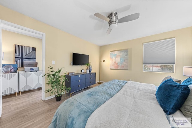 bedroom with ceiling fan, wood finished floors, and baseboards