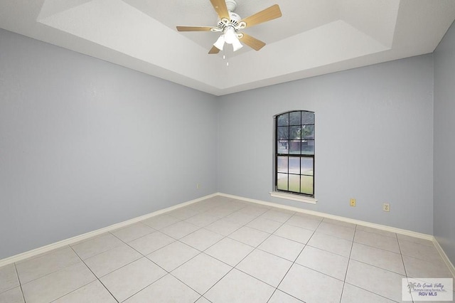 3100 Umar Ave, Mcallen, TX 78504 - unfurnished room featuring a tray ceiling, light tile patterned flooring, ceiling fan, and baseboards