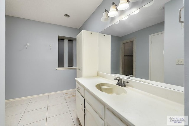 3100 Umar Ave, Mcallen, TX 78504 - bathroom with vanity, tile patterned flooring, and baseboards