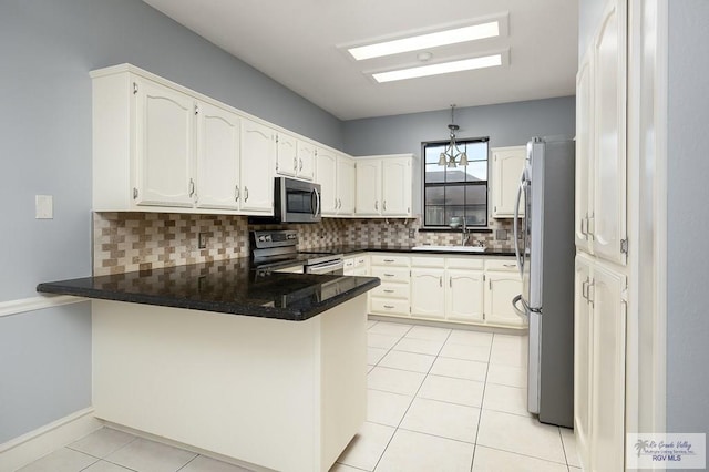 3100 Umar Ave, Mcallen, TX 78504 - kitchen with appliances with stainless steel finishes, a peninsula, light tile patterned floors, decorative backsplash, and a sink