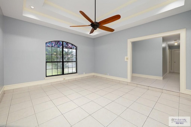 3100 Umar Ave, Mcallen, TX 78504 - unfurnished room featuring a tray ceiling, a ceiling fan, baseboards, and light tile patterned floors