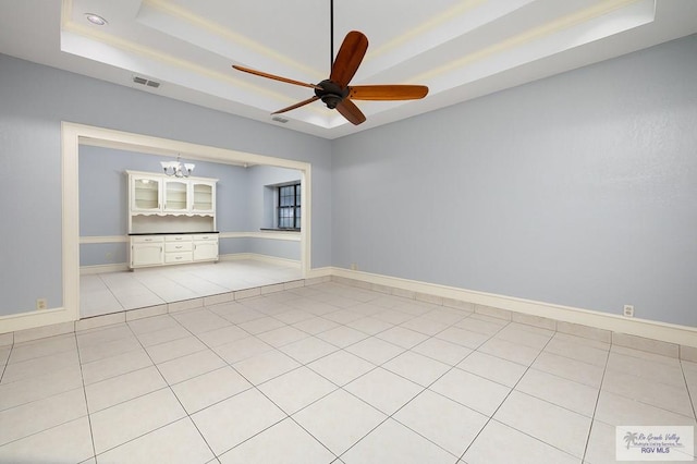 3100 Umar Ave, Mcallen, TX 78504 - empty room with a tray ceiling, ceiling fan, a chandelier, baseboards, and light tile patterned floors