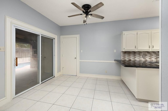 3100 Umar Ave, Mcallen, TX 78504 - unfurnished dining area featuring ceiling fan, light tile patterned flooring, and baseboards