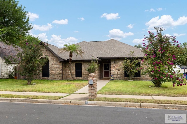 3100 Umar Ave, Mcallen, TX 78504 - view of front of property with a front yard, brick siding, and a shingled roof
