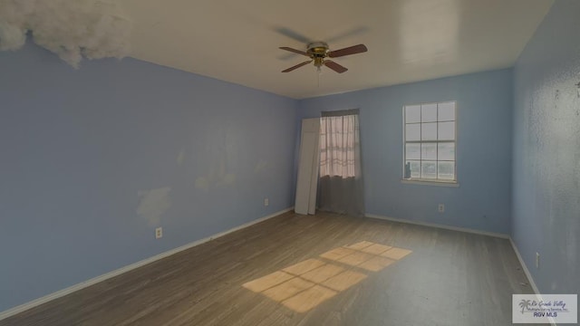 unfurnished room featuring ceiling fan and hardwood / wood-style floors