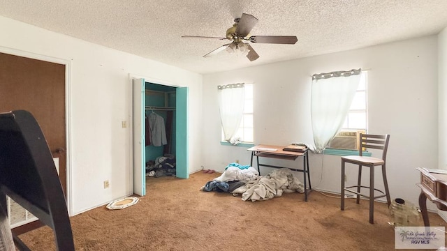 carpeted bedroom featuring ceiling fan, a closet, cooling unit, and a textured ceiling