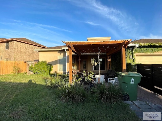 rear view of property with a lawn