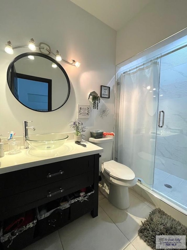 bathroom featuring a shower with shower curtain, vanity, tile patterned floors, and toilet