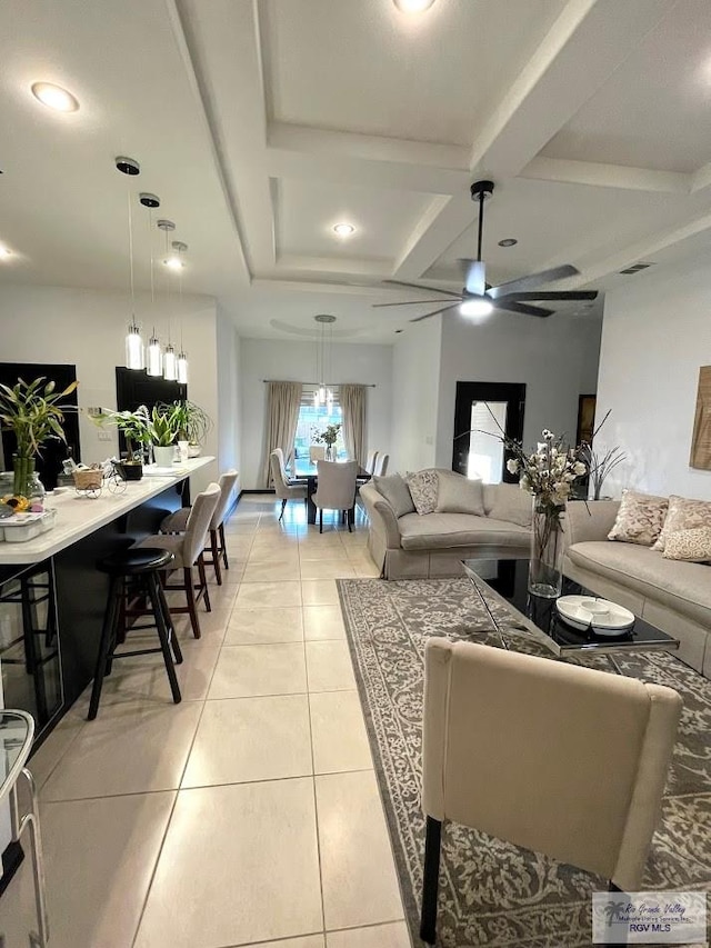 tiled living room featuring beamed ceiling, ceiling fan, and coffered ceiling