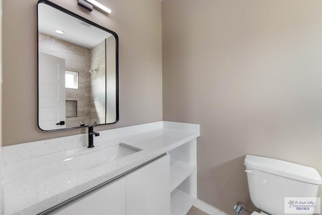 bathroom with vanity and toilet