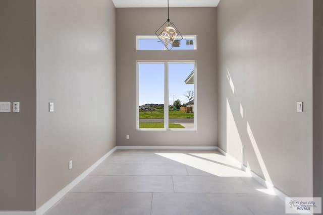 empty room featuring an inviting chandelier