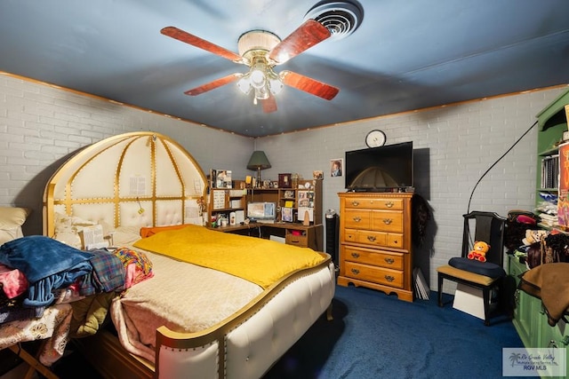 carpeted bedroom featuring ceiling fan and brick wall