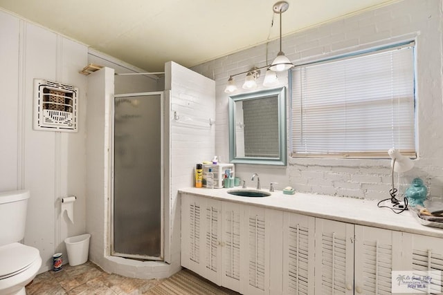 bathroom with tasteful backsplash, toilet, a shower with door, and sink