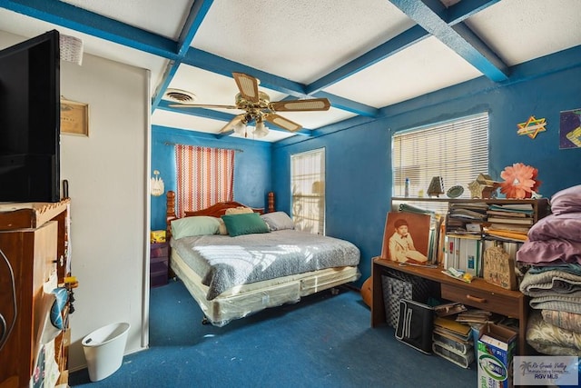 carpeted bedroom with beam ceiling and ceiling fan