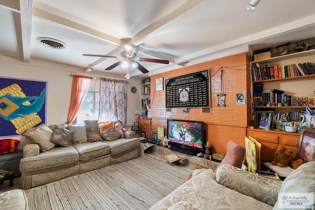 living room featuring ceiling fan and beamed ceiling