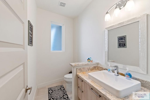 bathroom with tile patterned floors, vanity, and toilet