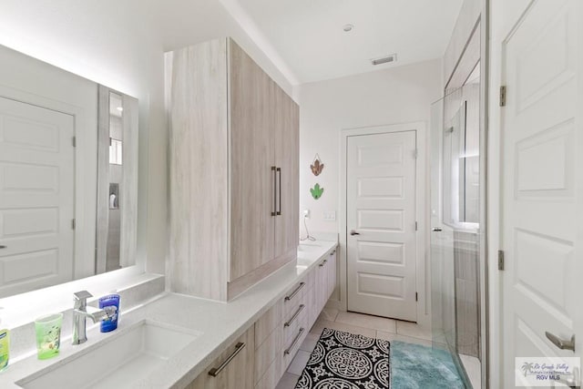 bathroom featuring vanity, tile patterned floors, and a shower with door