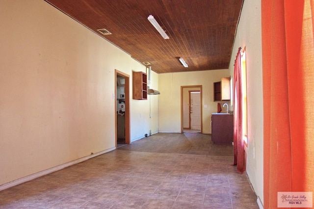 hallway featuring visible vents and wooden ceiling