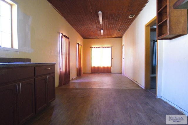 hallway featuring dark wood-style floors, visible vents, and wood ceiling