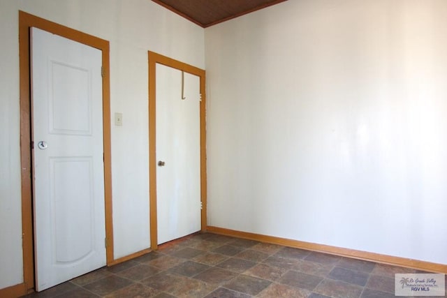 interior space featuring stone finish floor and baseboards