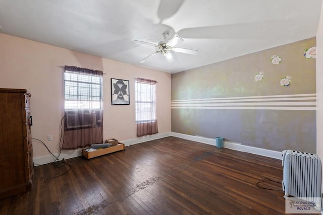 unfurnished room with hardwood / wood-style flooring, baseboards, and a ceiling fan