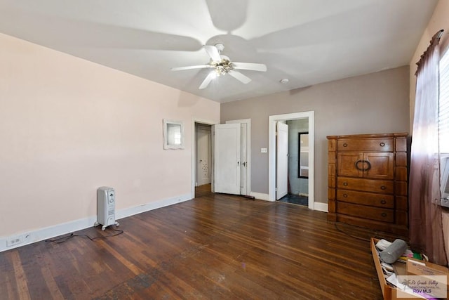 unfurnished bedroom featuring dark wood-type flooring, ceiling fan, and baseboards