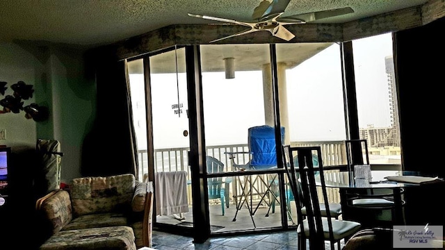 sunroom / solarium featuring ceiling fan