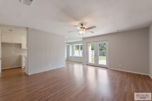 2310 W Arbor St, Harlingen, TX 78552 - unfurnished living room with ceiling fan, wood finished floors, baseboards, and french doors