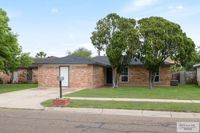 2310 W Arbor St, Harlingen, TX 78552 - single story home with central AC unit, brick siding, roof with shingles, and concrete driveway