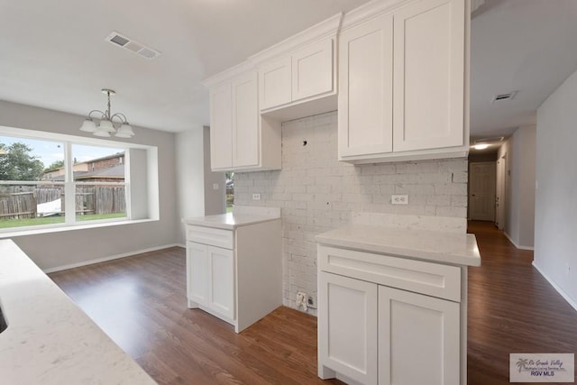 2310 W Arbor St, Harlingen, TX 78552 - kitchen featuring a chandelier, dark wood finished floors, white cabinetry, and baseboards