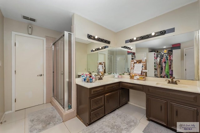 134 Camaguey Ave, Brownsville, TX 78526 - bathroom with a shower stall, tile patterned flooring, and vanity