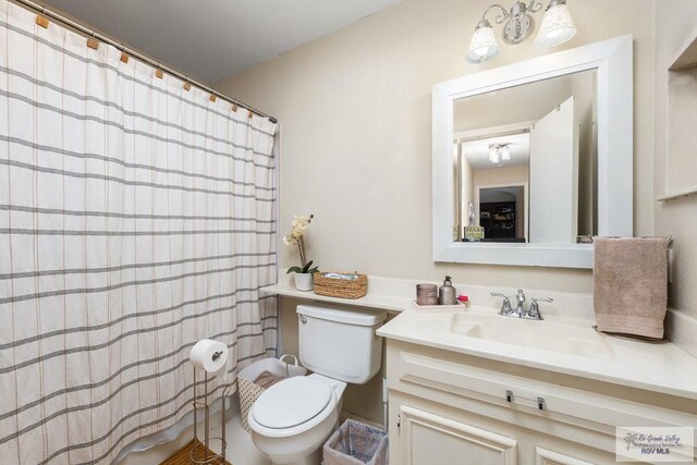 134 Camaguey Ave, Brownsville, TX 78526 - bathroom with toilet, vanity, and curtained shower