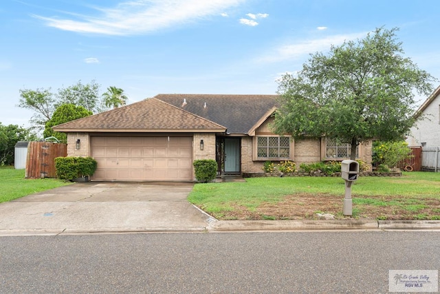 134 Camaguey Ave, Brownsville, TX 78526 - single story home featuring driveway, a garage, brick siding, and roof with shingles