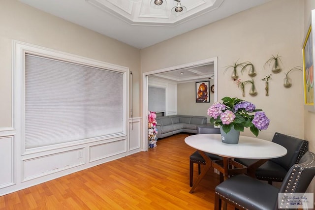 134 Camaguey Ave, Brownsville, TX 78526 - dining space with light wood-style flooring, a chandelier, and a wainscoted wall