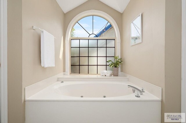 3406 Spyglass Hill Dr, Harlingen, TX 78550 - bathroom with a tub with jets, healthy amount of natural light, and lofted ceiling