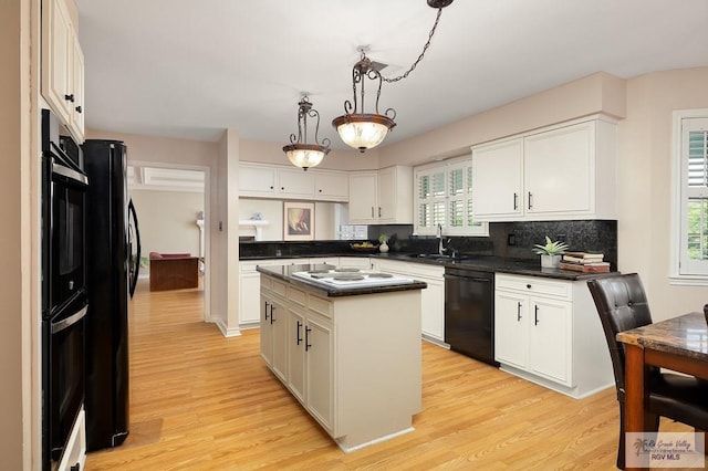 3406 Spyglass Hill Dr, Harlingen, TX 78550 - kitchen with black appliances, a sink, dark countertops, light wood-type flooring, and healthy amount of natural light