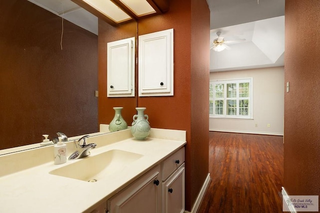 3406 Spyglass Hill Dr, Harlingen, TX 78550 - bathroom featuring wood finished floors, vanity, baseboards, and a ceiling fan
