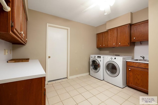 3406 Spyglass Hill Dr, Harlingen, TX 78550 - washroom with cabinet space, washing machine and dryer, light tile patterned flooring, and baseboards