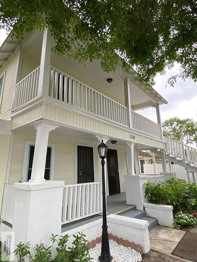 view of front of home featuring covered porch and a balcony