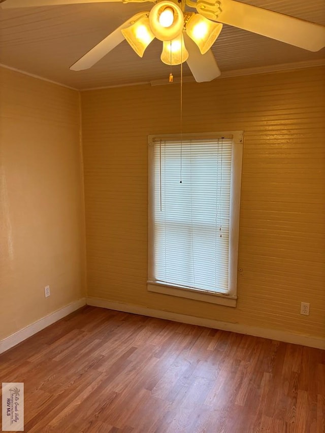 spare room with hardwood / wood-style floors, ceiling fan, and crown molding