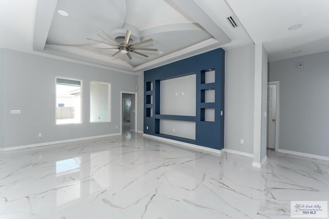 unfurnished room featuring ceiling fan and a tray ceiling