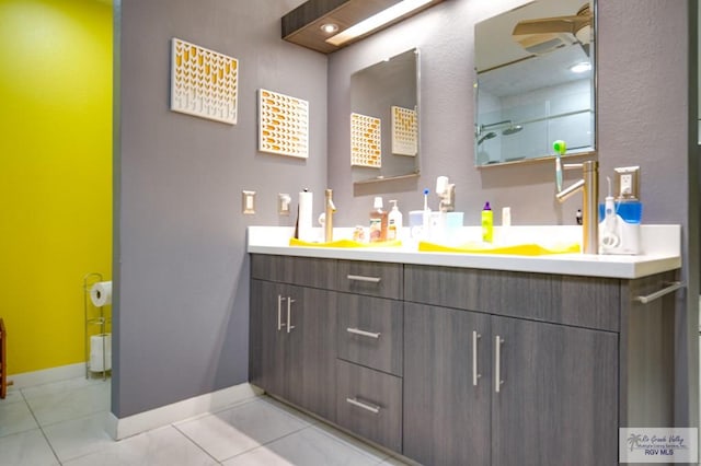 bathroom with tile patterned floors, vanity, and ceiling fan